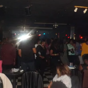 a crowd of people standing and sitting