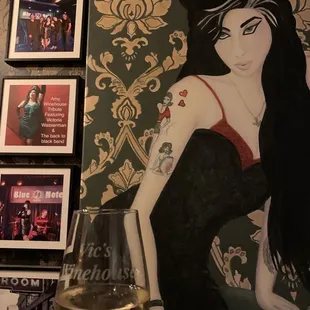 a woman in a black dress and a glass of wine