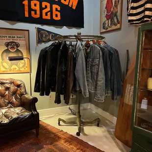 Men's denim jackets, leather jackets, leather club chair and art.