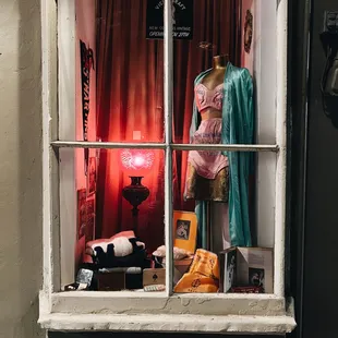 Store display window with antique clothing