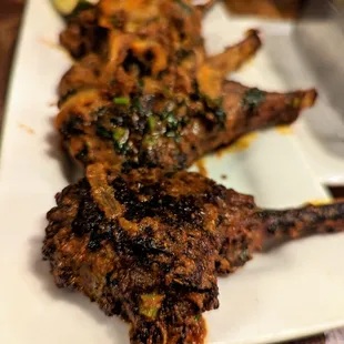 Lamb Lollipops. $27. French rack of lamb marinated in masala spices and cooked to a tender and charred medium well. Best I&apos;ve had. No joke.