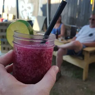 a hand holding a drink