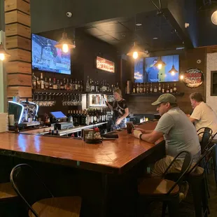 two men sitting at a bar