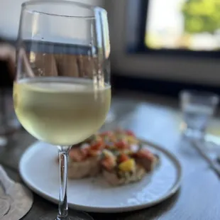 a glass of wine and a plate of food