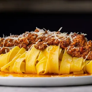 a plate of pasta with meat and cheese