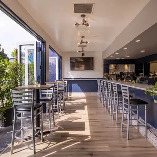 a view of a restaurant with a bar and chairs