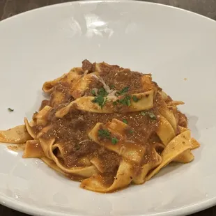 a plate of pasta with meat and sauce