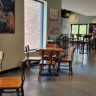 the inside of a restaurant with tables and chairs