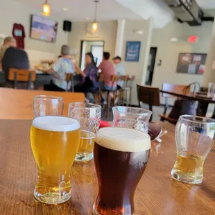 a row of beer glasses on a table