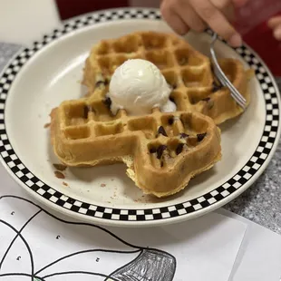 a plate of waffles with ice cream