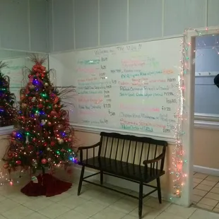 a decorated christmas tree and a bench