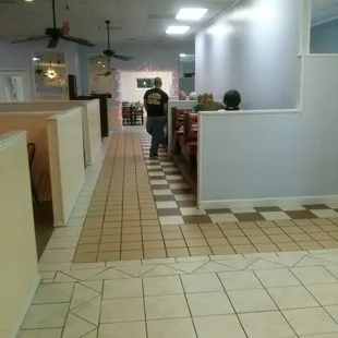 a woman walking down the hallway
