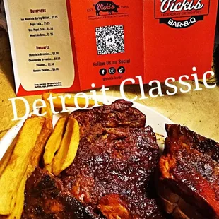 ows a plate of ribs and french fries