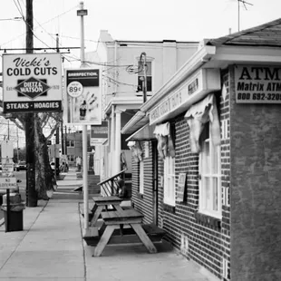 a black and white photo of a street corner