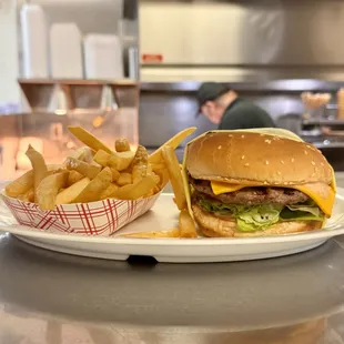 Indulge in the ultimate comfort combo: our juicy cheeseburger paired with crispy fries. Satisfaction in every bite!