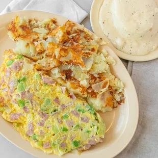 Indulge in a classic Denver omelette, packed with savory ham, diced onion, and vibrant bell peppers, creating a harmonious blend of flavors.