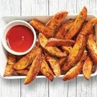 a plate of fries with ketchup
