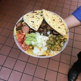a person holding a plate of food