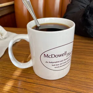 a cup of coffee with a spoon in it