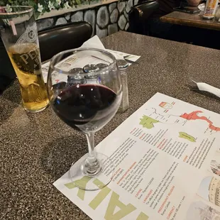 a glass of wine and a menu