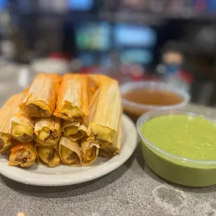 a plate of enchillas and a bowl of guacamole