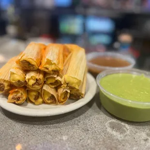 a plate of enchillas and a bowl of guacamole