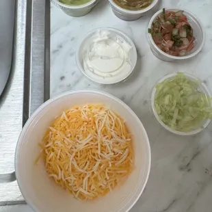 Shredded lettuce, shredded cheese and various sauces (i.e. sour cream, pico, guacamole)