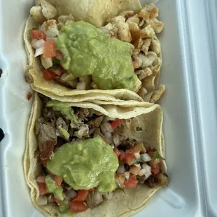 Grilled chicken taco and carnitas taco