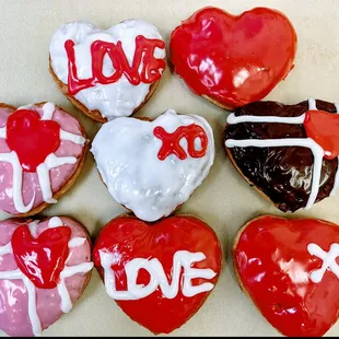 a variety of valentine&apos;s day donuts
