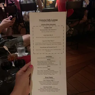 a hand holding a menu