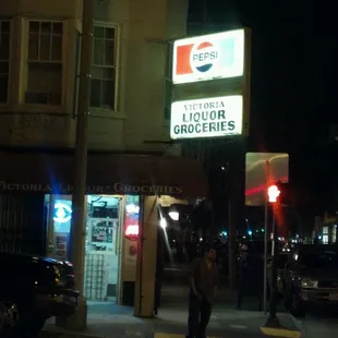a woman walking down the street at night
