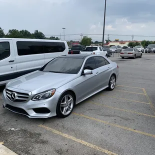 a silver mercedes parked in a parking lot