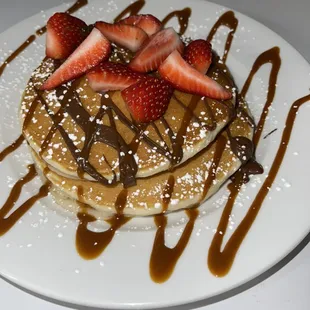 Chocolate chip pancakes with caramel syrup and strawberries