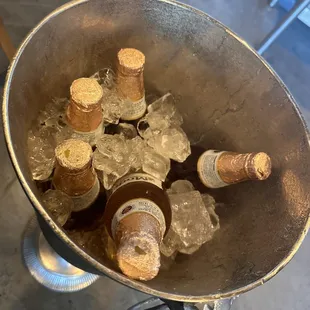 a bucket full of bottles of beer