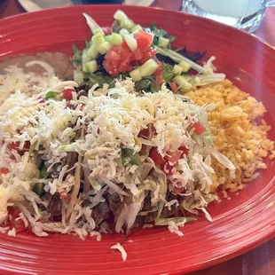 Tacos desebrados rice beans and a salad.