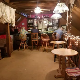 people sitting at tables in a pub
