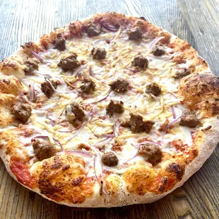 a pizza with meat and cheese