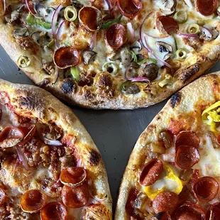 three pepperoni pizzas