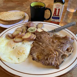 T-Bone steak   2  eggs over easy, parsley, buttered, potatoes, rye, toast, and coffee