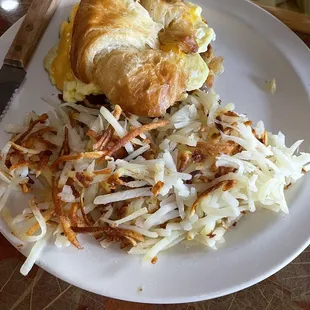 Sausage egg and cheese breakfast sandwich with hash browns