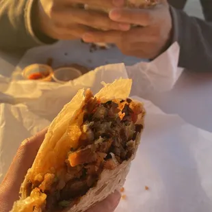 a person eating a burrito