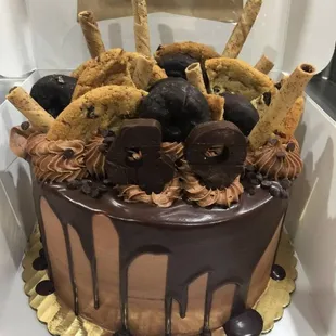 a chocolate cake decorated with cookies and chocolate icing