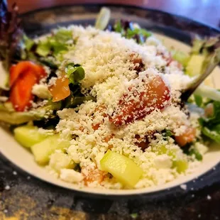 Side salad: cucumbers,  tomatoes,  strawberries, a delicious balsamic and queso fresco crumbles