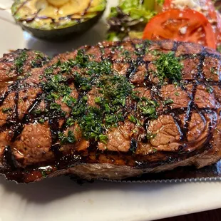 14oz NY strip with grilled avocado and tomatoes.
