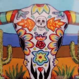 a cow skull with colorful flowers on it