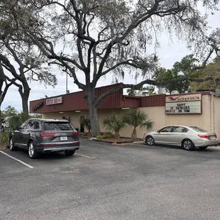 two cars parked in front of the restaurant