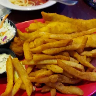 Fried fish with seasoned fries and coleslaw.