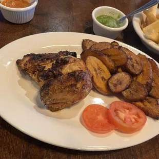 Quarter chicken breast it's plantains and yuca fries
