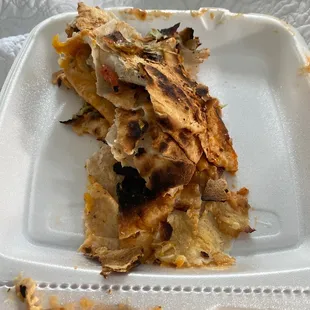 a piece of pizza in a styrofoam container