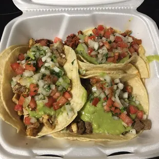 three tacos in a styrofoam container